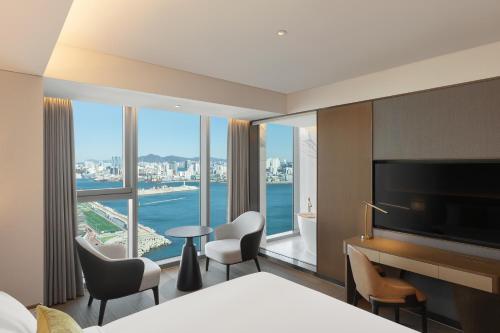 a hotel room with a view of the water at Wyndham Grand Busan in Busan