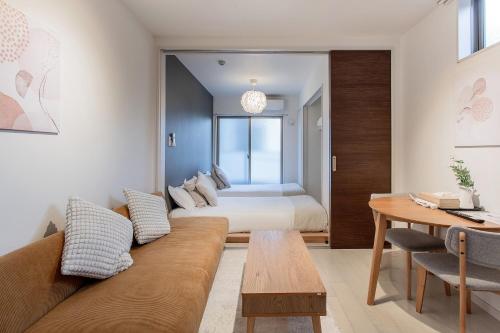 a living room with a couch and a bed at 剛田今里 in Osaka