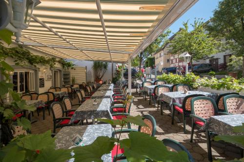 a row of tables and chairs on a patio at Zum Fässle in Hagnau