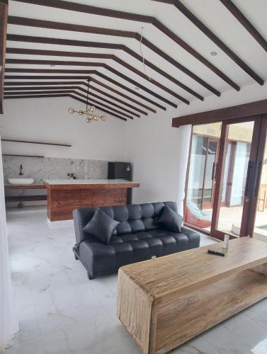 a living room with a couch and a coffee table at Pine Tree Beach Hotel in Gili Trawangan