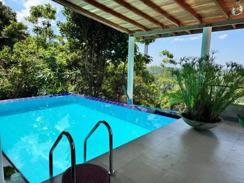 a swimming pool with a view of the trees at The Ellen Horizon in Ganegama South
