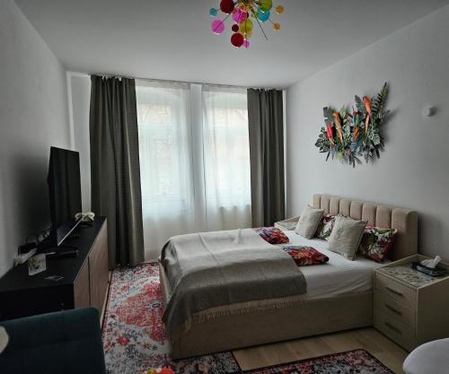 a bedroom with a bed and a television in it at Art House Olymp in Bamberg