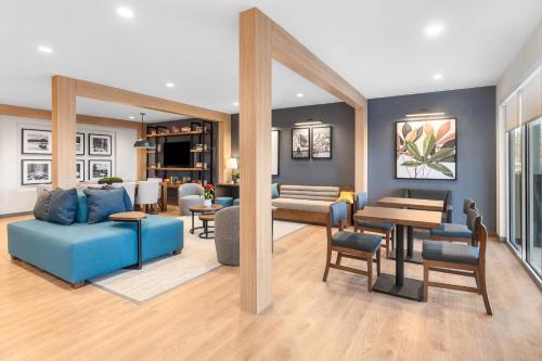 a living room with a blue couch and a table at Everhome Suites Clarksville Ft Campbell Area by Choice Hotels in Clarksville