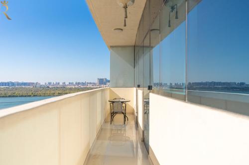 a view from the balcony of a building with a table at Chic 2BR - Bright Balcony Bliss in Al Reem in Abu Dhabi