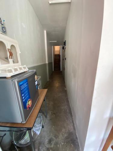 a hallway with a tv sitting on a table at SridaHouse#Near Central Festival Hat Yai in Sathani Khlong Rian