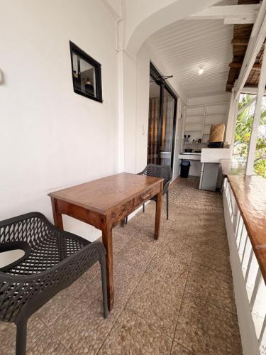 a room with a wooden table and two chairs at New Studio with Balcony , General Luna in General Luna