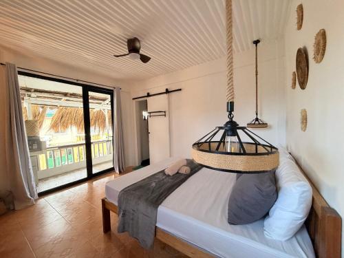 a bedroom with a bed with a hanging basket at New Studio with Balcony , General Luna in General Luna