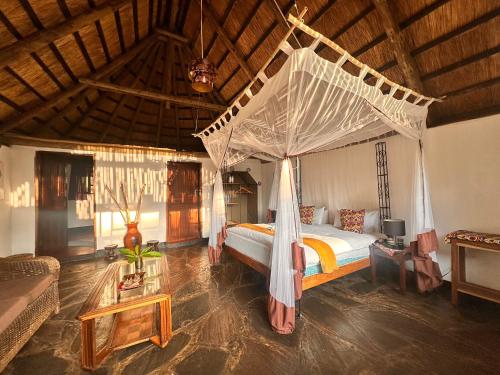a bedroom with a bed with a canopy at Pioneer Camp in Lusaka