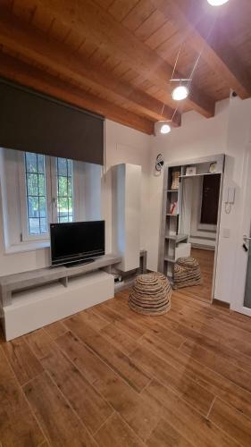 a large living room with a flat screen tv at Casetta gialla in Brianza - Monticello Brianza - NON E' CASATENOVO in Casatenovo