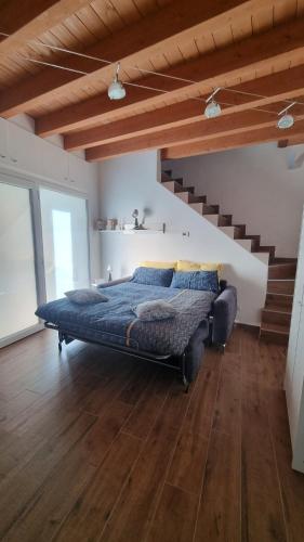 a bedroom with a bed in a room with stairs at Casetta gialla in Brianza - Monticello Brianza - NON E' CASATENOVO in Casatenovo