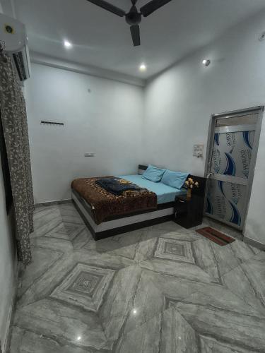 a bedroom with a bed and a tiled floor at Jai Krishna Guest House in Ayodhya