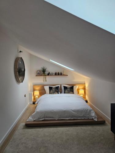 a bedroom with a large bed with two lamps at Mountain Whisper Chalet in Braşov