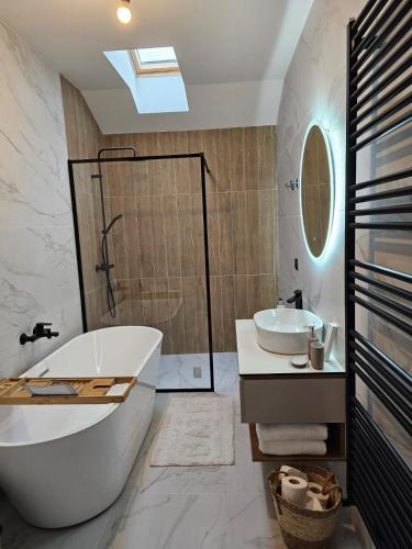 a bathroom with a tub and a sink at Mountain Whisper Chalet in Braşov