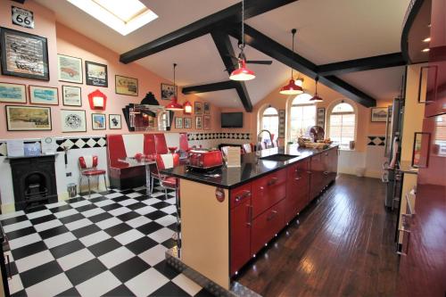 a kitchen with a black and white checkered floor at The PitStop in Bishops Stortford