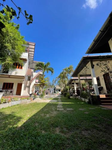 a view of a yard between two buildings at Ron Bungalow in Bang Tao Beach