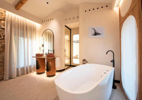 a large bathroom with a tub and a sink at Hotel Sarela Natura in Santiago de Compostela