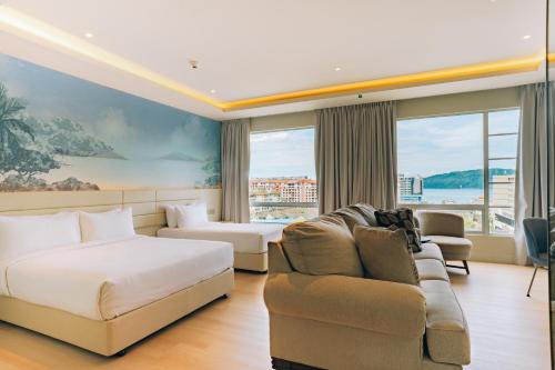 a hotel room with a bed and a couch at Cititel Express Kota Kinabalu in Kota Kinabalu