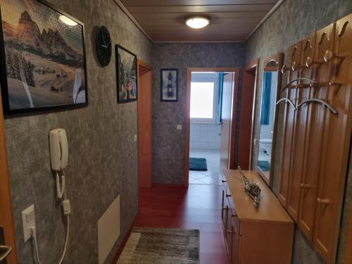 a bathroom with a sink and a phone on the wall at Ferienwohnung in Klein Düngen in Bad Salzdetfurth