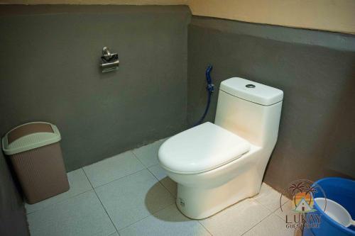 a bathroom with a toilet and a trash can at Lukay Guest House in Siquijor in Lazi