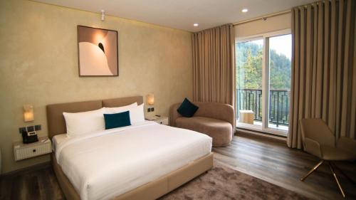 a hotel room with a bed and a balcony at Zesora Nathia Gali in Nathia Gali