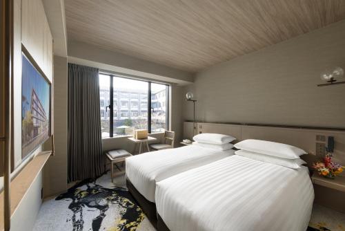 a hotel room with a large bed and a window at THE HOTEL HIGASHIYAMA KYOTO TOKYU, A Pan Pacific Hotel in Kyoto