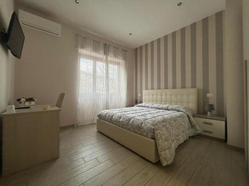 a bedroom with a bed and a large window at La Suite in Cassino