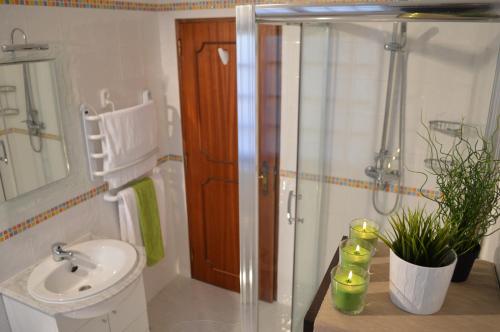 een badkamer met een douche, een toilet en een wastafel bij Casa Grande Holidays in São Martinho do Porto