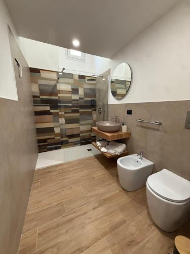 a bathroom with a white toilet and a sink at LIONS ROOMS Augusta in Augusta