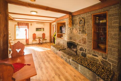 a living room with a stone wall with a fireplace at Õuna Puhketalu in Jõgeva