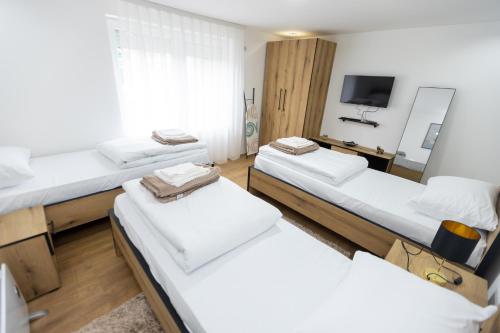 a group of four beds in a room at Bakina kuca in Pirot