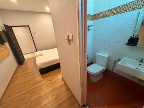 a bathroom with a toilet and a sink at Tropical Villa Kuantan in Kuantan