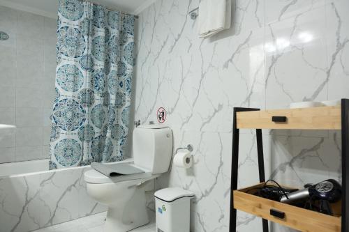 a bathroom with a toilet with a laptop on it at Acropolis luxury home in Athens