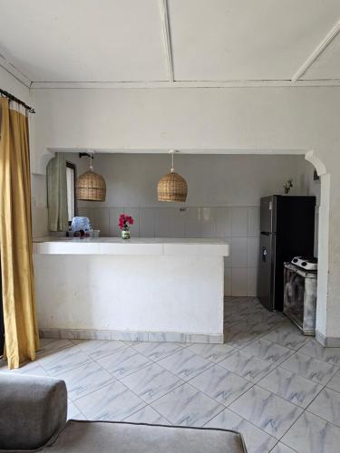 a kitchen with a counter and a refrigerator at Casalola in Mombasa