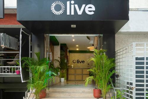 a store front with plants in front of it at Olive Zip Rest House Road by Embassy Group in Bangalore