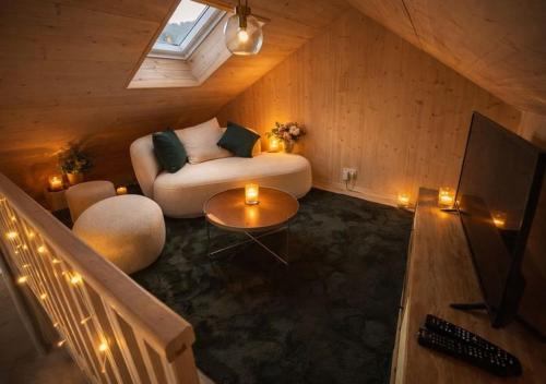 a living room with a couch and a tv at Meuse Cottage in Hastière-par-delà