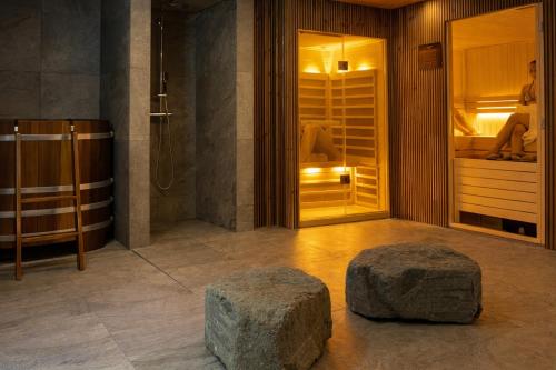a bathroom with two rock stools on the floor at Hvanndalir Lodge in Ólafsfjörður