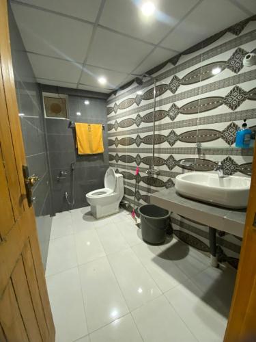 a bathroom with a sink and a toilet at Mount Vista Resort in Murree