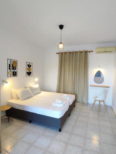 a bedroom with a bed and a chair in it at Panagiotis Studios 2 in Laganas