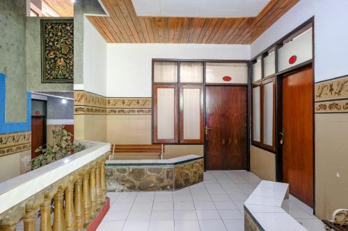 a lobby of a building with a jacuzzi tub at RedDoorz near Jawa Timur Park 1 in Batu
