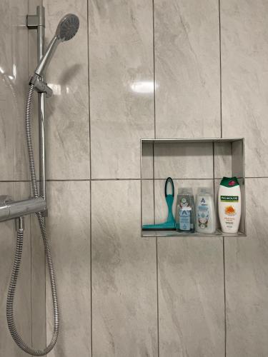 a bathroom with a shower with a shower head at Greenway Cottage in Baltonʼs Cross Roads