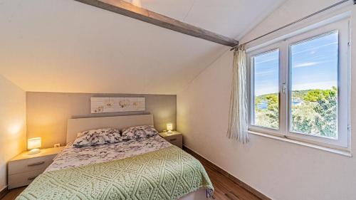 a bedroom with a bed and a large window at Apartman Roza 2 by Villas Guide in Vela Luka