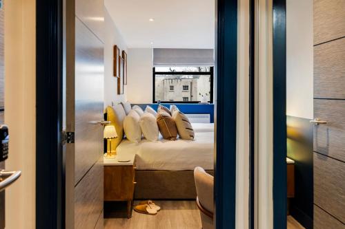 a bedroom with a bed with pillows and a table at Your Apartment I Clifton Village in Bristol