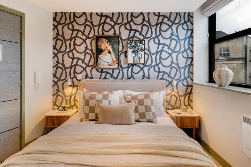 a bedroom with a bed and a wall mural at Your Apartment I Clifton Village in Bristol