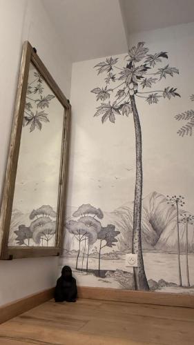 a mirror on a wall with a drawing of a tree at Gîte Lydmalida cocon Ardéchois in Les Ollières-sur-Eyrieux