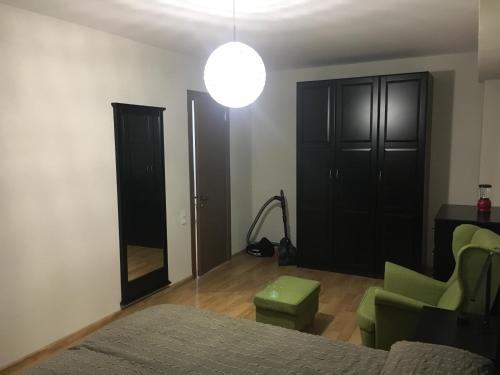 a bedroom with a bed and a chair and a mirror at Apartments 315 New Gudauri 2 blok in Gudauri