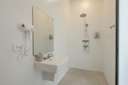 a white bathroom with a sink and a mirror at Savana- Wild Pool Villa I 6 en-suite bedrooms in Chiang Mai