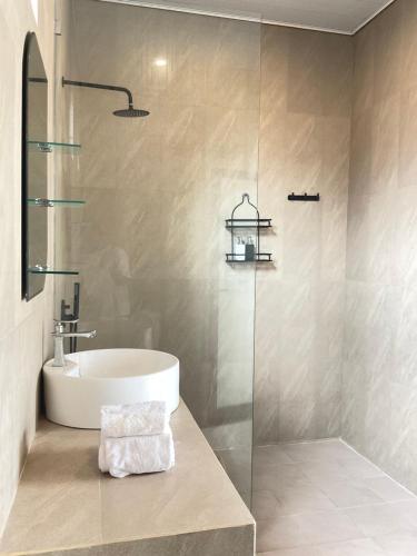 a bathroom with a sink and a shower at Twin House Villa in Canggu