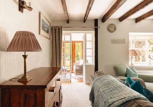a living room with a couch and a table with a lamp at New Haven in Elie