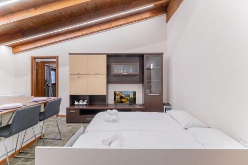 a living room with a white couch and a table at EasyHome Malpensa Milano - self-check-in in Somma Lombardo