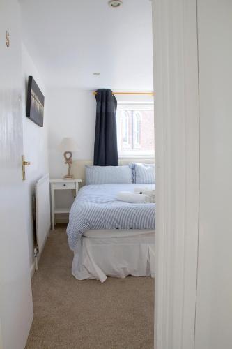 a bedroom with a bed and a window at Timrick Lodge in Weymouth